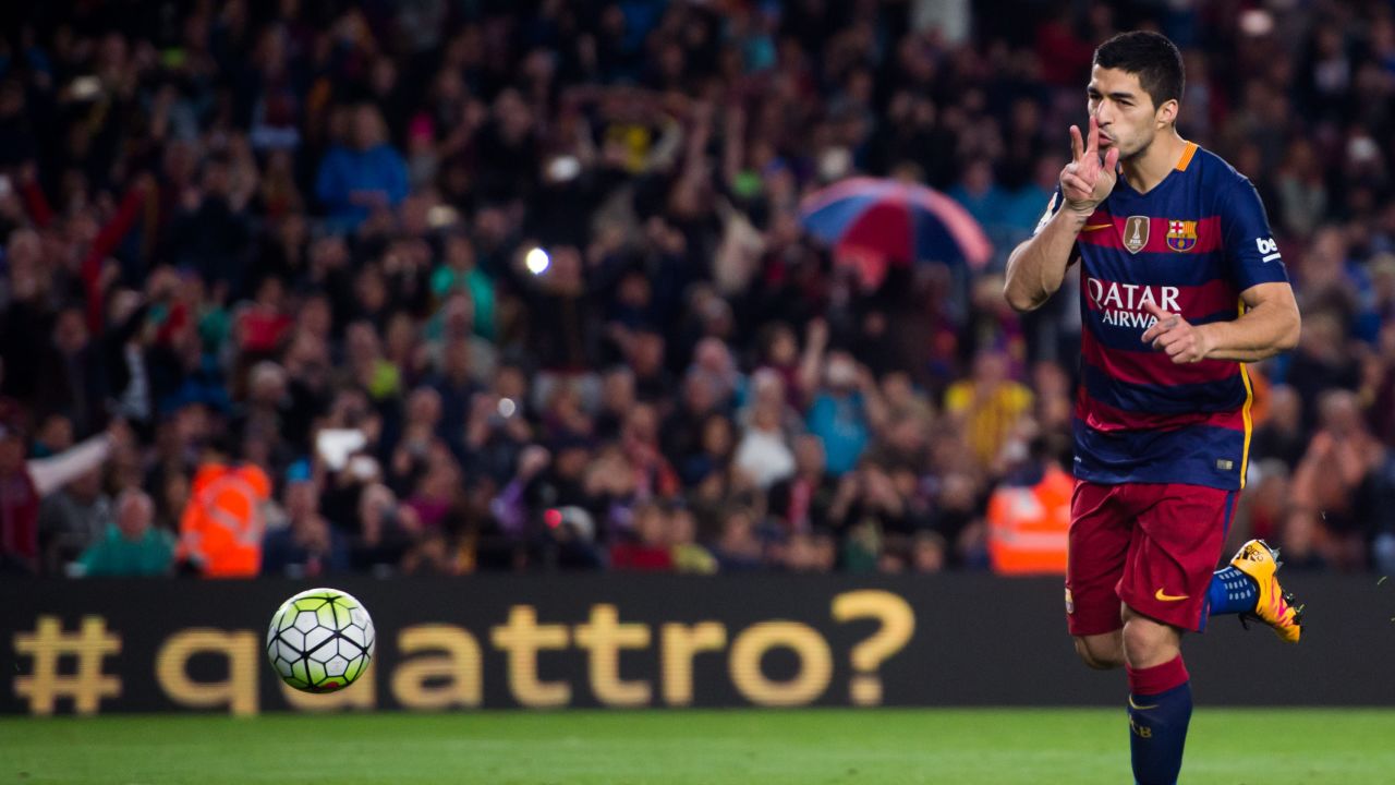 Luis Suarez celebrates after scoring Barcelona's fourth goal against Sporting Gijon.