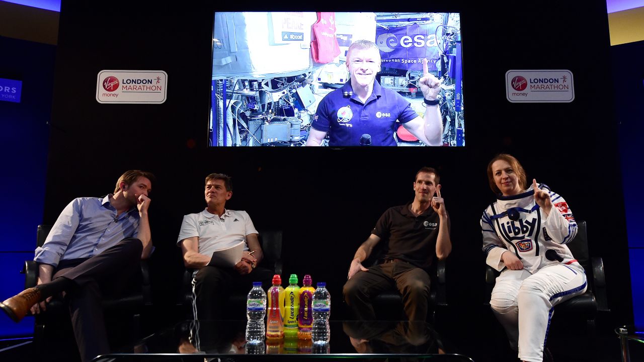 British astronaut Tim Peake, on screen, speaks at a news conference ahead of the London Marathon.