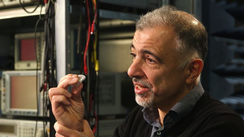 Consisting of a specially designed silicon microchip attached to a USB stick, this "lab-on-a-chip" can perform a DNA test in under 30 minutes and for as little as $20.  Pictured, Toumazou holding a microchip at Imperial College, London.  