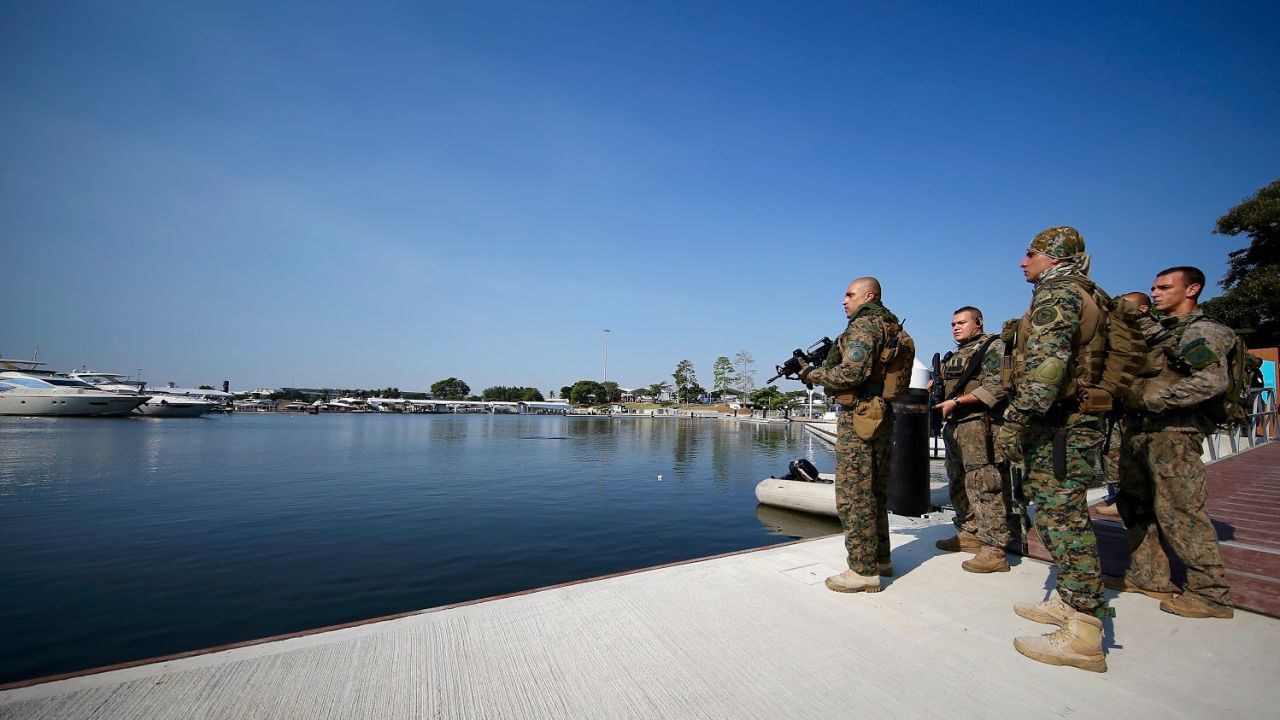 Members of Brazil's military police at the marina which will be home to Olympic sailing events. Water pollution at this venue and security concerns are just two of the issues Rio organizers face.