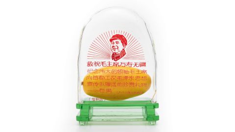 The political message of the gift was clear: workers, not students, would be in charge of the Cultural Revolution. The symbol was quickly adopted and mangoes were bused into provincial towns and exhibited in public. Display cases, like this one, were given to workers as merit awards. 