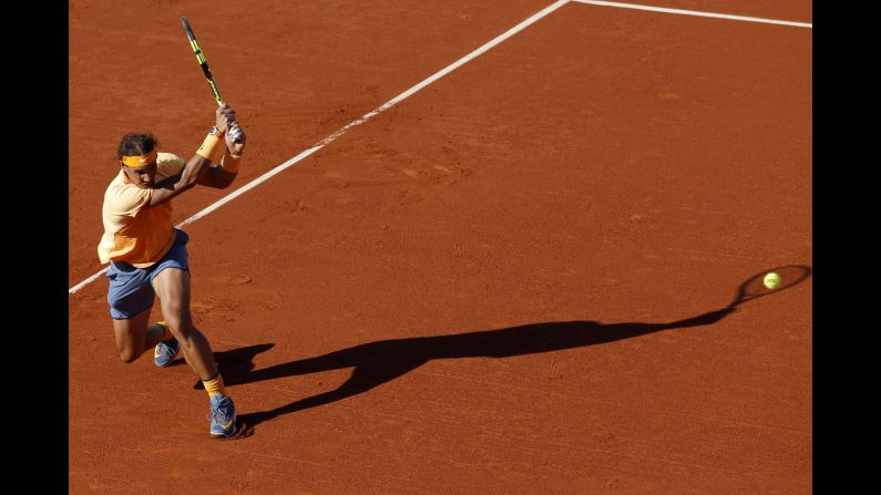Rafael Nadal returns a ball during the Barcelona Open final, which he won Sunday, April 24, in Barcelona, Spain. It is Nadal's 49th clay-court title, <a href="index.php?page=&url=http%3A%2F%2Fwww.cnn.com%2F2016%2F04%2F24%2Ftennis%2Ftennis-barcelona-nadal-nishikori-vilas%2Findex.html" target="_blank">tying the record</a> set by Guillermo Vilas.