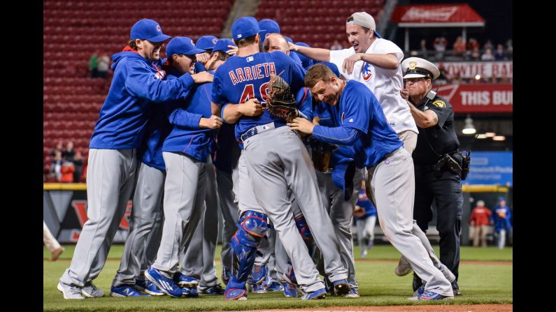 Chicago Cubs pitcher Jake Arrieta is surrounded by teammates -- and an overzealous fan -- <a href="index.php?page=&url=http%3A%2F%2Fbleacherreport.com%2Farticles%2F2634754-jake-arrieta-throws-no-hitter-vs-reds-stats-highlights-and-reaction" target="_blank" target="_blank">after throwing a no-hitter</a> in Cincinnati on Thursday, April 21. It was the second career no-hitter for Arrieta, who won the National League Cy Young Award last season.