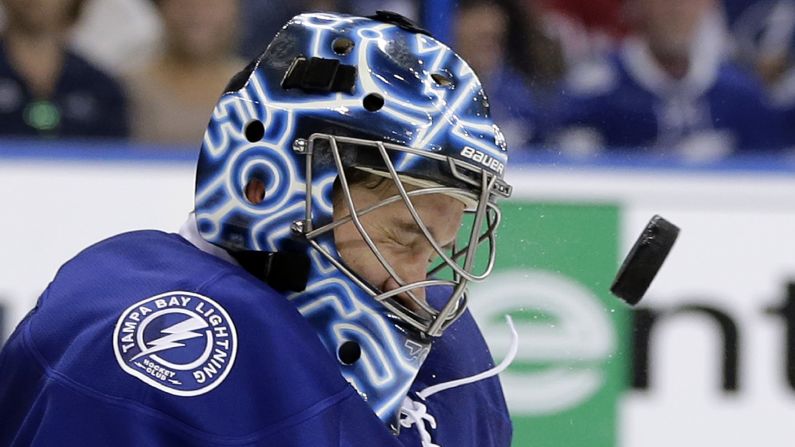 Tampa Bay goalie Ben Bishop takes a shot off the mask during an NHL playoff game on Thursday, April 21. The Lightning advanced to the second round after eliminating Detroit in five games.