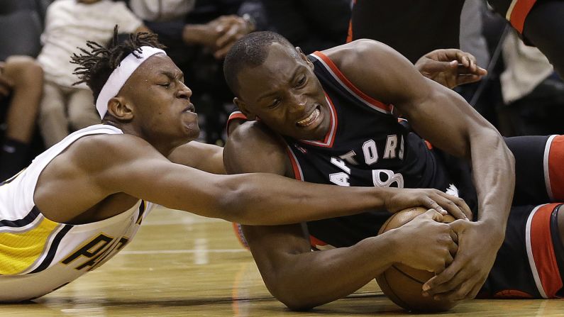 Indiana's Myles Turner, left, and Toronto's Bismack Biyombo battle for a loose ball during an NBA playoff game in Indianapolis on Saturday, April 23. Indiana won the game to tie the series at two games apiece.