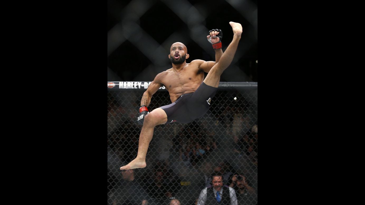 UFC flyweight champion Demetrious Johnson celebrates after he beat Henry Cejudo on Saturday, April 23. The fight was stopped in the first round.