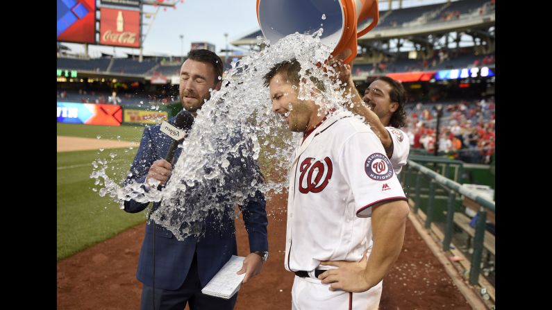 Anthony Rendon douses Washington teammate Chris Heisey and TV reporter Dan Kolko after a victory over Minnesota on Sunday, April 24. Heisey hit a walk-off home run in the 16th inning.