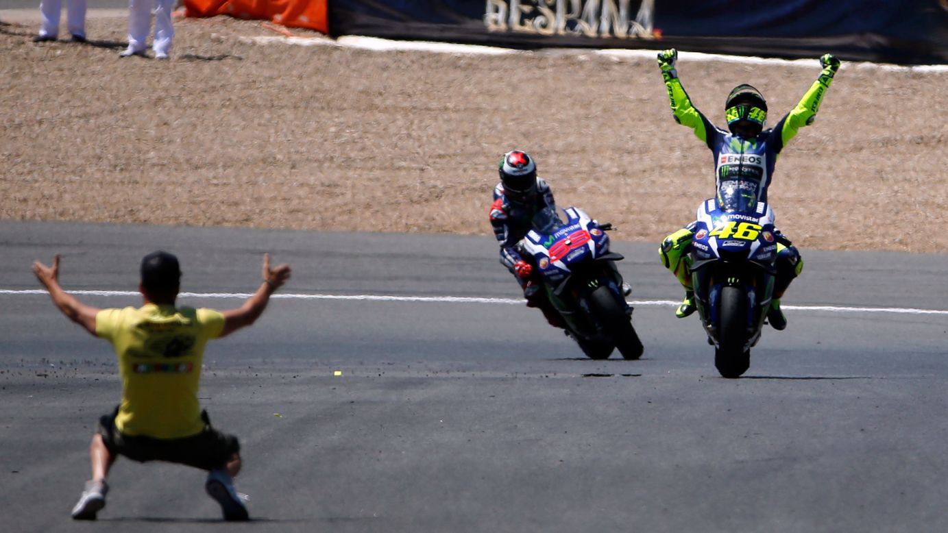 MotoGP rider Valentino Rossi, right, celebrates after winning in Spain on Sunday, April 24.