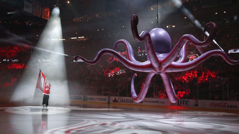 Former Detroit Red Wings player Darren McCarty carries a flag on the ice before the team hosted an NHL playoff game on Tuesday, April 19. <a href="index.php?page=&url=http%3A%2F%2Fwww.cnn.com%2F2016%2F04%2F19%2Fsport%2Fgallery%2Fwhat-a-shot-sports-0419%2Findex.html" target="_blank">See 29 amazing sports photos from last week</a>