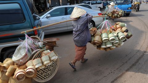 Women hawk hand-made bamboo baskets in downtown Vientiane on February 29, 2008.  Laos is among world's poorest countries. AFP PHOTO/HOANG DINH Nam (Photo credit should read HOANG DINH NAM/AFP/Getty Images)