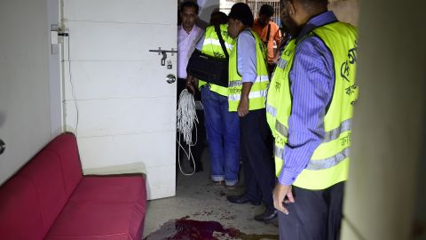 Bangladeshi police examine the scene of an attack on a publisher on October 31, 2015.