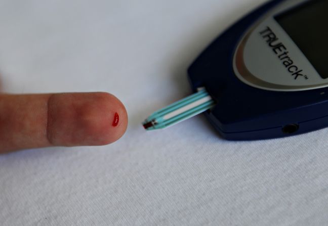 Toumazou's microchip technology has the potential to reveal a person's predisposition to a variety of hereditary diseases, including type two diabetes. Pictured, a patient with diabetes monitors his blood glucose with a glucometer.