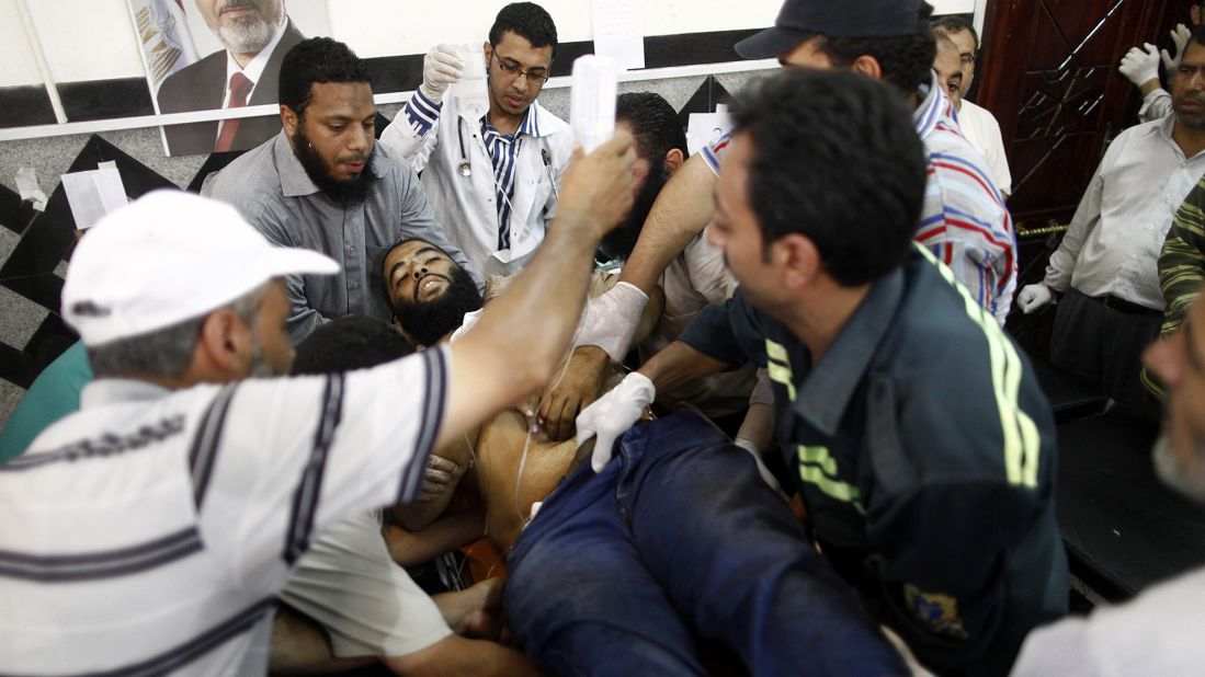 An injured man is carried into a makeshift hospital after clashes between Egyptian police and Morsy supporters in July 2013. Morsy was ousted in a military coup after a year in office.