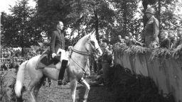 Following an exhibition, Austrian Colonel Alois Podhajsky (1898 - 1973) (left, on horseback), director of the Spanish Riding School, formally requests that American military commander General George S. Patton (1885 - 1945) protect the historic school and its Lipizzaner horses, St. Martin, Austia, May 7, 1945. (Photo by PhotoQuest/Getty Images)