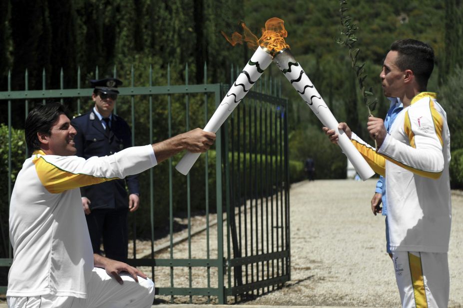 Petrounias passed the Olympic flame to a second torchbearer on April 21 -- Brazilian volleyball player, Giovane Gávio (L).