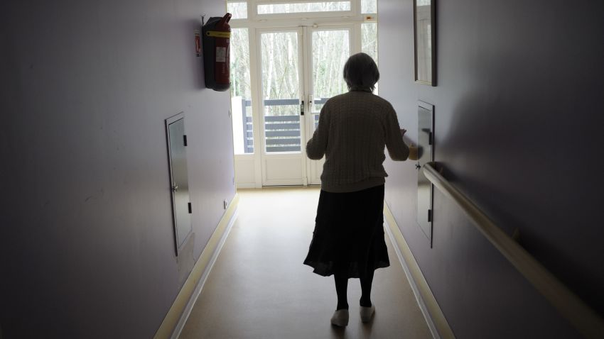 A woman, suffering from Alzheimer's desease, walks in a corridor on March 18, 2011 in a retirement house in Angervilliers, eastern France.   AFP PHOTO / SEBASTIEN BOZON (Photo credit should read SEBASTIEN BOZON/AFP/Getty Images)