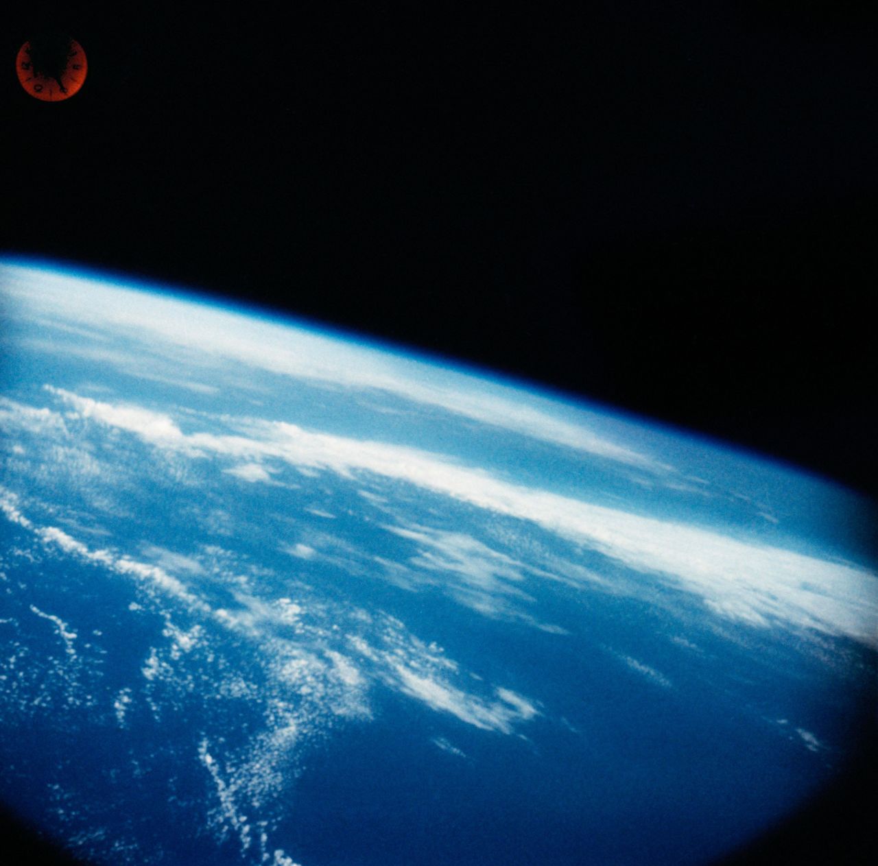 Shepard's view of Earth wasn't as blue as this photo taken from the capsule. A gray filter was inadvertently left on Shepard's periscope window, so he saw Earth in black and white. He still said, "What a beautiful view!"