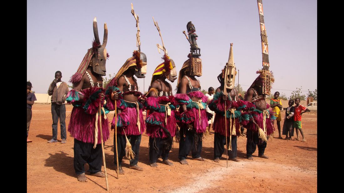 Audiences are able to see performers in Dogon masks from Mali take to the floor at Dedougou's stadium. Masks such as the kanaga and santimbe (center) are intended to ensure the passage of the dead into the realm of the ancestors, whilst the sirige (right) has been argued to symbolize a multistory house.
