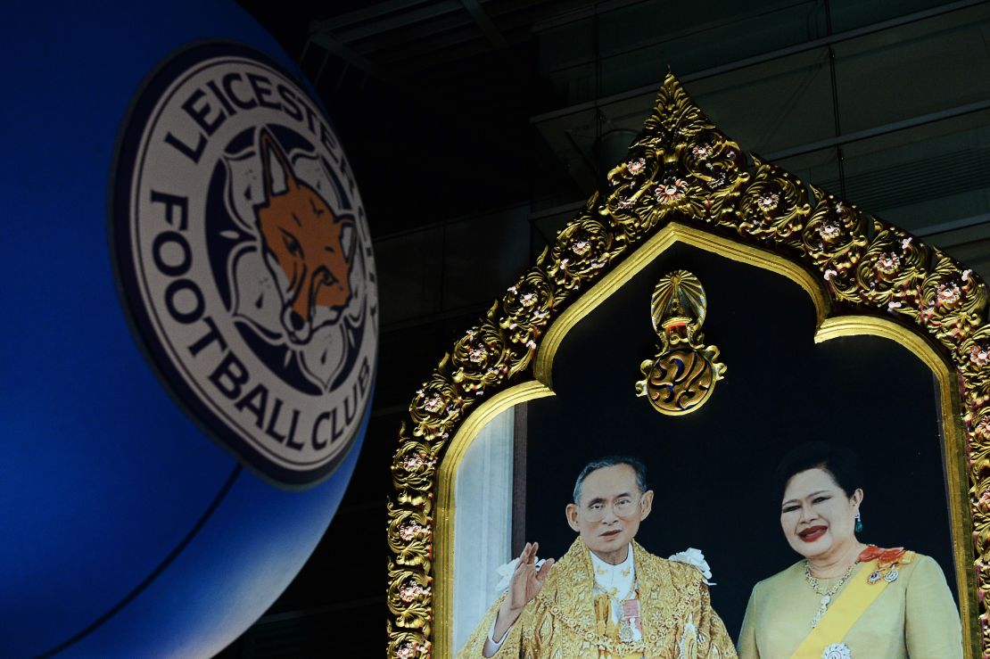 Leicester's club logo next to a portrait of Thai King Bhumibol Adulyadej and Queen Sirikit. 