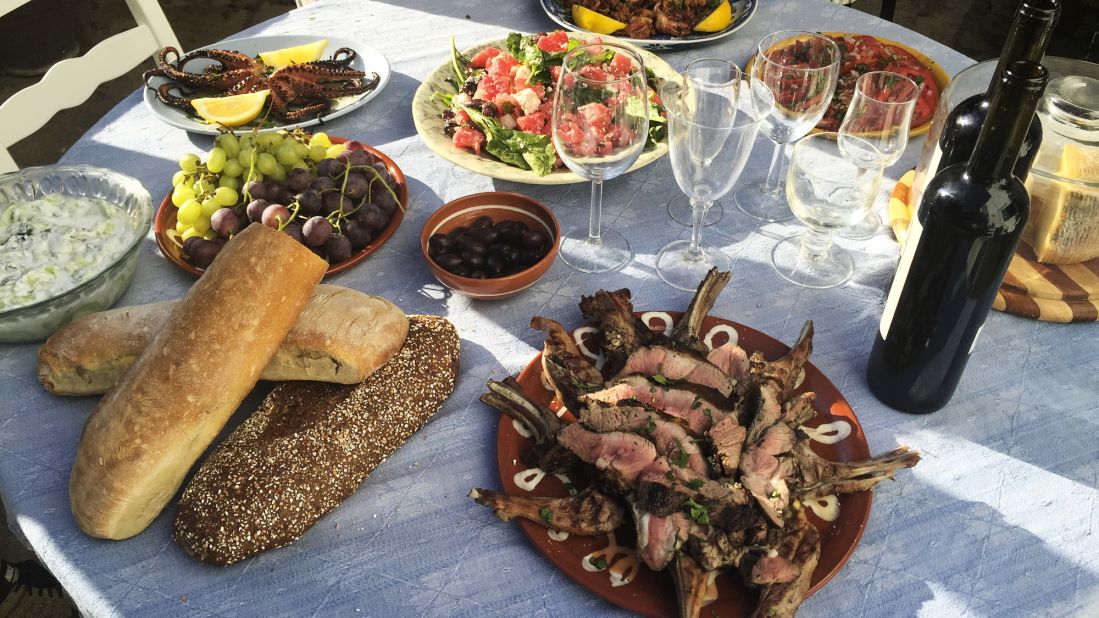 Bourdain speads out a feast -- lamb chops, octopus, calamari, local Naxian cheese, olives and salad -- at his rented villa.