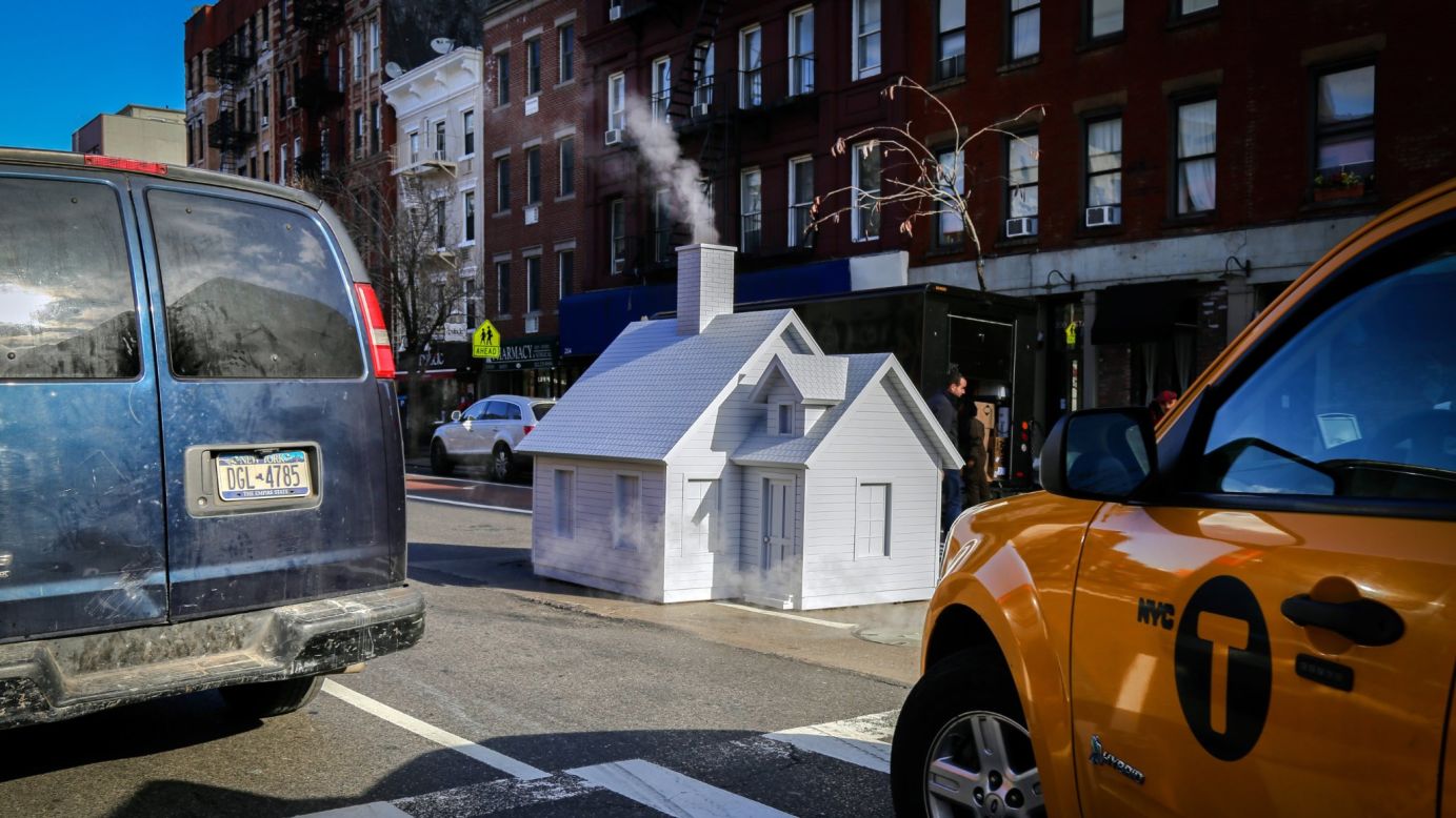 A tiny house, designed by artist Mark Reigelman II, covers a manhole in New York on Thursday, April 28. Reigelman <a href="http://www.slate.com/blogs/the_eye/2016/04/27/smokers_by_mark_a_reigelman_ii_is_a_roving_tiny_house_on_the_streets_of.html" target="_blank" target="_blank">created several of these</a> in the city.