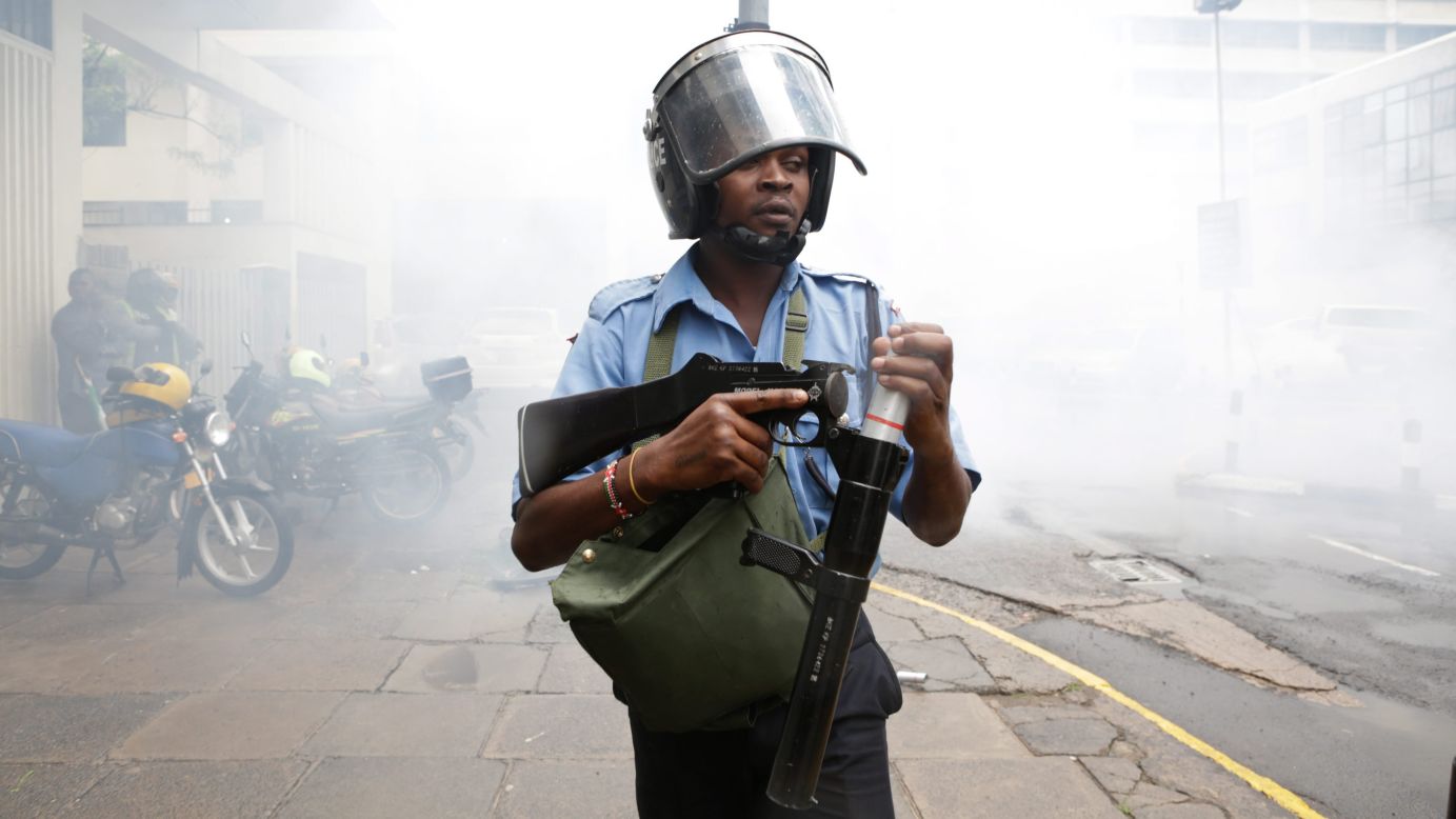 A police officer in Nairobi, Kenya, loads his teargas launcher to disperse opposition protesters on Monday, April 25.