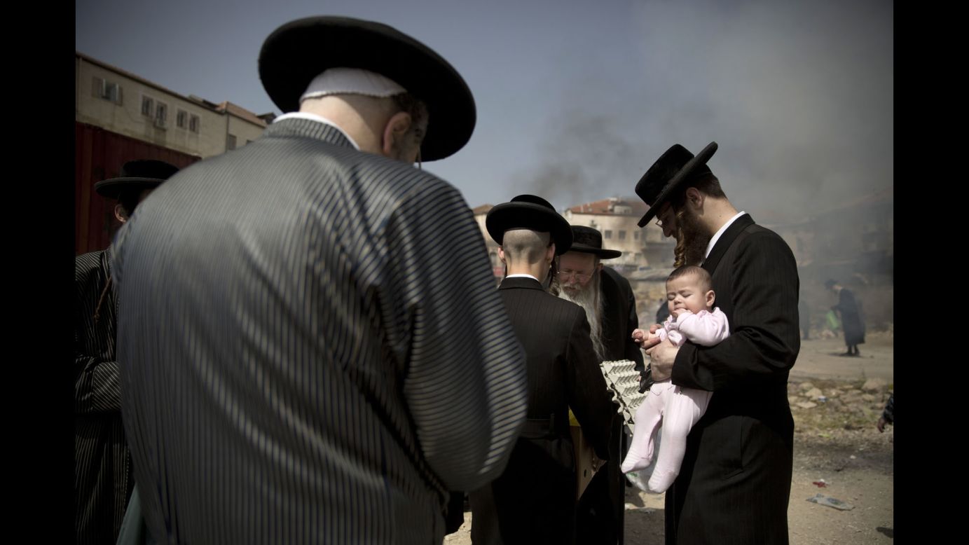 Ultra-Orthodox Jewish men burn leavened items in Jerusalem as they prepare for the Passover holiday on Friday, April 22.