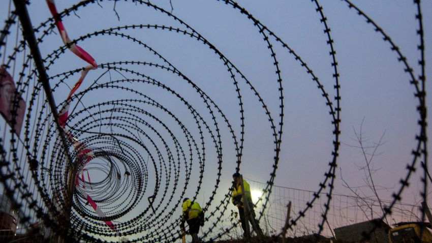 Workers complete a 3.7 kilometer stretch of fence at the Spielfeld border crossing between Austria and Slovenia in December.