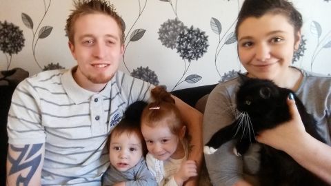 Bella poses with her family