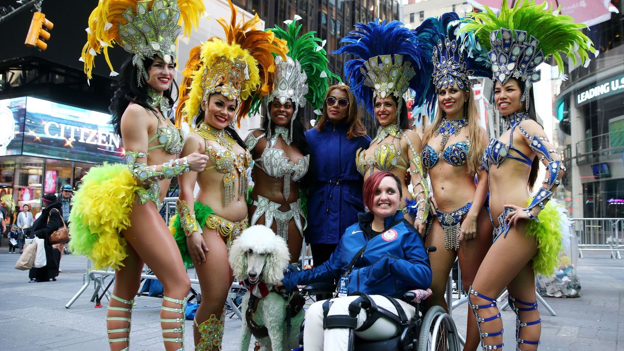  Paralympic equestrian star Sydney Collier poses with samba dancers during Team USA's Road to Rio Tour event.