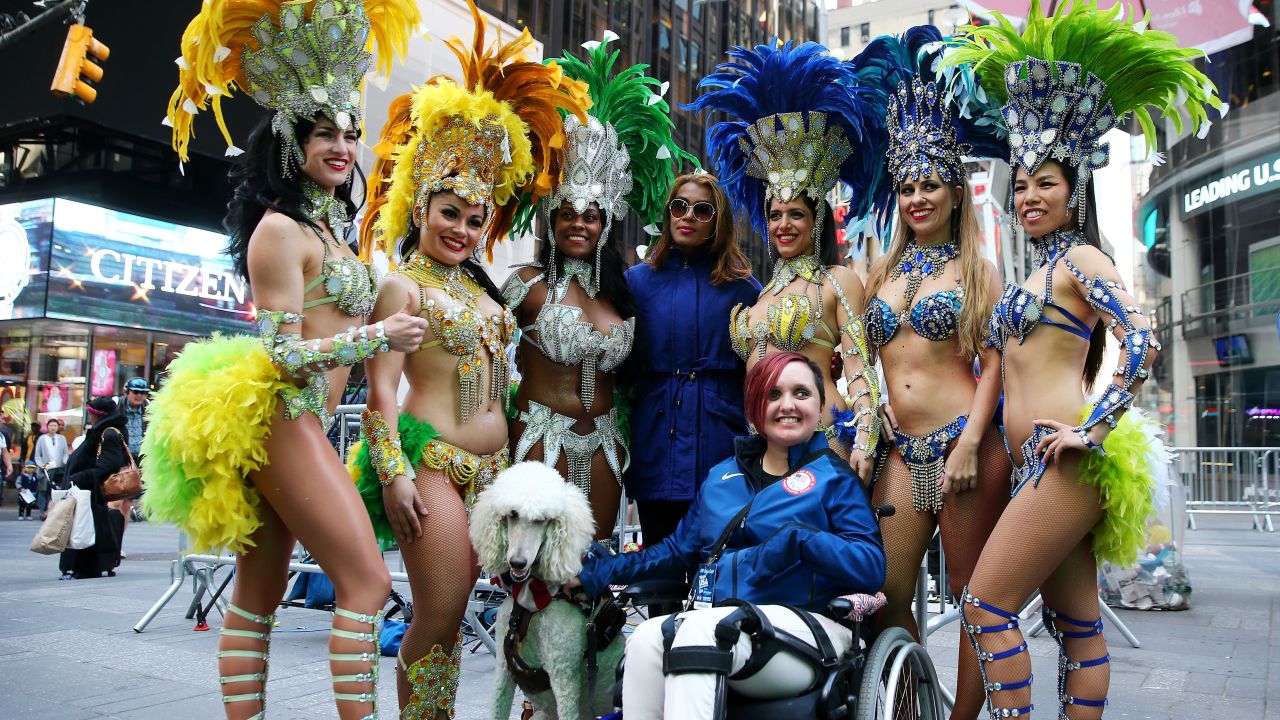 Paralympic equestrian star Sydney Collier poses with samba dancers during Team USA's Road to Rio Tour event.