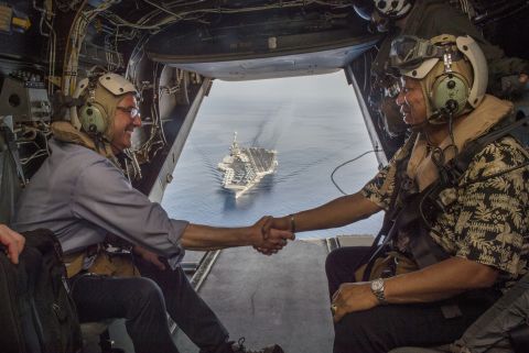 U.S. Secretary of Defense Ash Carter (left) and Philippine Secretary of National Defense Voltaire Gazmin shake hands on a Marine Corps V-22 Osprey as they depart the the aircraft carrier USS John C. Stennis (CVN 74) after touring the aircraft carrier as it sailed in the South China Sea on April 15, 2016. 