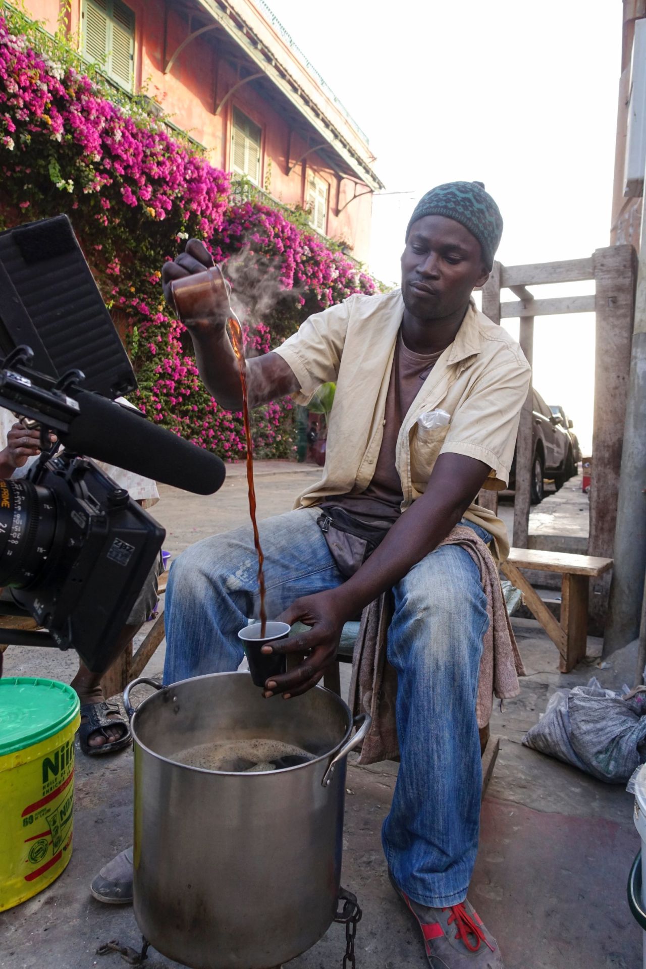 A vendor pours Cafe Touba --coffee made with djar, an African black pepper, and sugar -- in Saint-Louis.