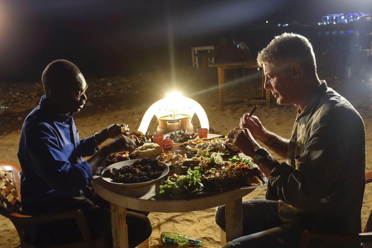 Later that same night, Bourdain and Chef Pierre Thiam enjoy a seafood dinner in Dakar at Cour de Cassation Beach, one of Thiam's favorite beach shack "restaurants."  
