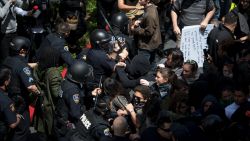 Police and protesters clash outside the Hyatt Regency Hotel where US Republican presidential candidate Donald Trump was speaking in Burlingame, California on April 29, 2016.  
Hundreds of protesters jostled with police in riot gear outside a California hotel where Republican presidential frontrunner Donald Trump was to give a speech, forcing the candidate to duck into a back entrance. / AFP / Josh Edelson        (Photo credit should read JOSH EDELSON/AFP/Getty Images)