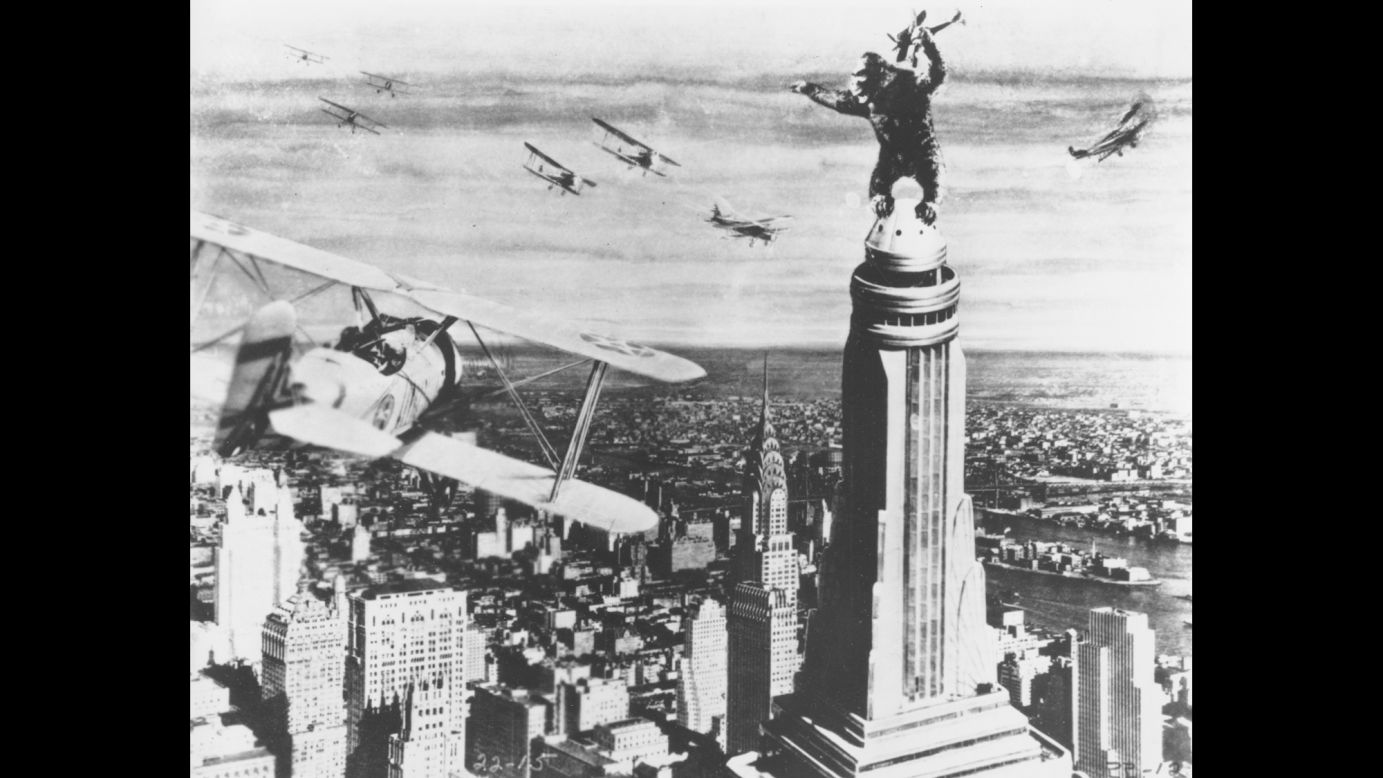 King Kong stands atop the Empire State Building as he holds an airplane during an attack by fighter planes in a scene from the film "King Kong." The movie was released on May 2, 1933.
