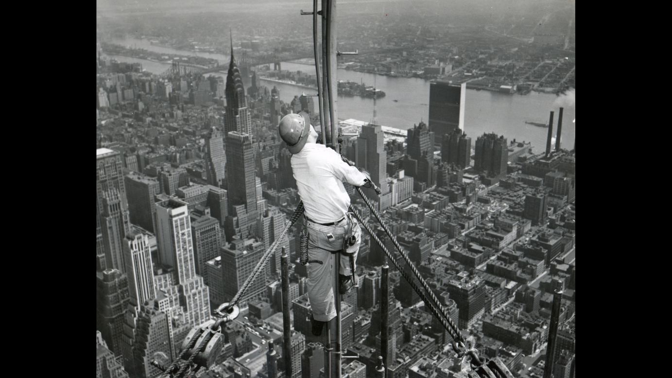 A worker attaches the temporary television antenna in 1950. A year later, the building is sold for $34 million.