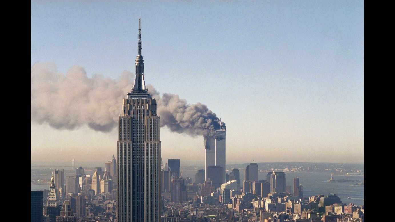 The twin towers of the World Trade Center burn behind the Empire State Building in New York, on <a href="http://www.cnn.com/2013/07/27/us/september-11-anniversary-fast-facts/" target="_blank">September 11, 2001</a>.