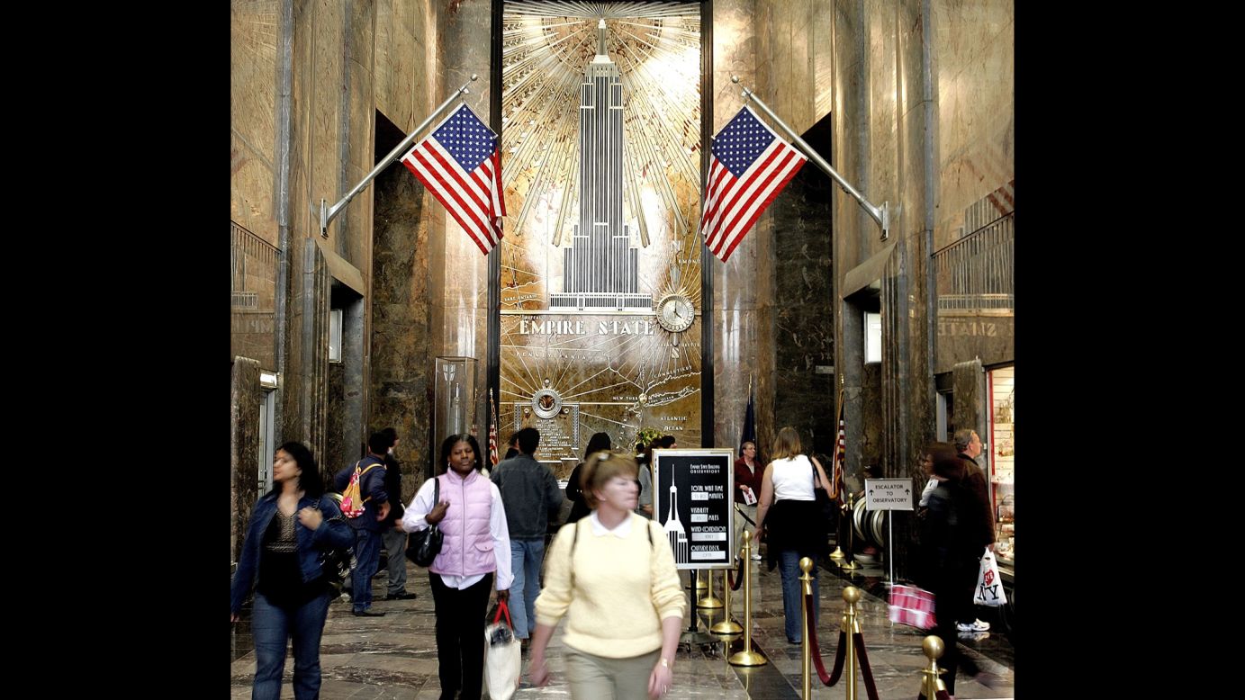 People walk through the lobby of the Empire State Building on its 75th anniversary on May 1, 2006.