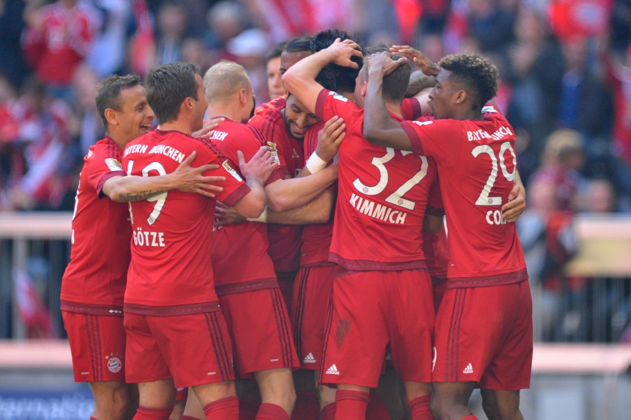 Serdar Tasci (C) of Bayern Munich celebrates scoring his team's first goal with his teammates.