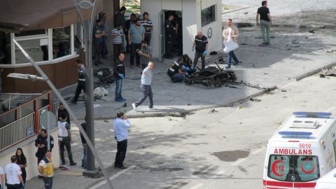 Police officers examine the scene outside the police headquarters in Gaziantep after the blast.
