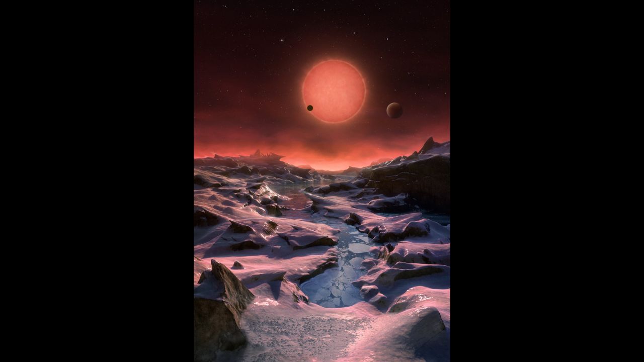 This artist's impression shows an imagined view from the surface one of the three planets orbiting an ultracool dwarf star just 40 light-years from Earth that were discovered using the TRAPPIST telescope at ESO's La Silla Observatory. Given the proximity of the dwarf star, the rosy sun would appear very large in the sky. 