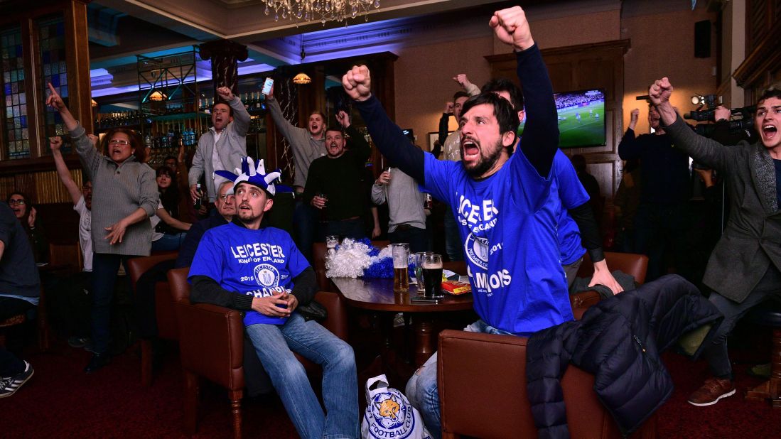 Leicester City fans watch the Chelsea-Tottenham match at a pub in Leicester, England, on Monday, May 2. The match ended 2-2, giving Leicester City its first Premier League title in club history. The Foxes were a 5,000-to-1 shot when the season started.
