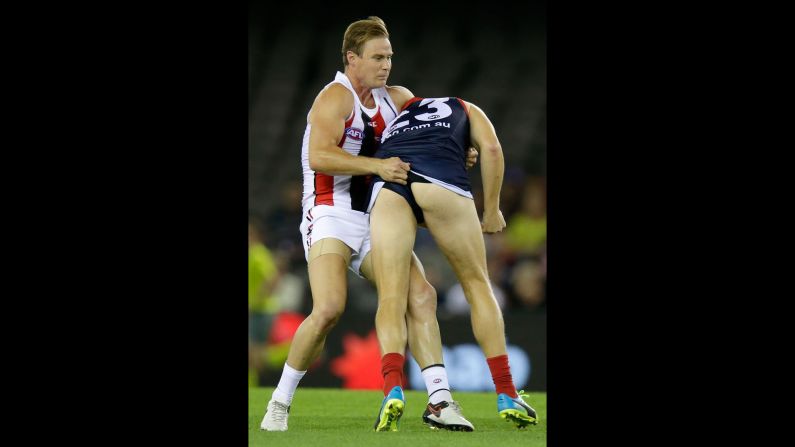 David Armitage of the St. Kilda Saints tackles Bernie Vince of the Melbourne Demons during an Australian Football League match in Melbourne on Saturday, April 30.
