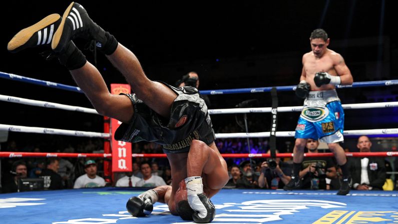 James DeGale rolls backward after losing his footing in Washington on Saturday, April 30. DeGale recovered to win a unanimous decision over Rogelio Medina.