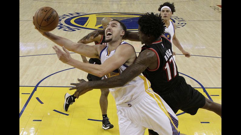 Golden State's Klay Thompson is fouled by Portland's Ed Davis as he scores in an NBA playoff game on Sunday, May 1. Thompson had 37 points for the Warriors, who won the first game of the second-round series 118-106.