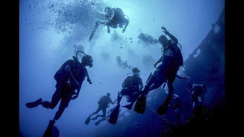 Sailors from the United States and Sri Lanka swim near the Tokai Maru, a sunken Japanese freighter from World War II, during a diving exercise in Guam on Wednesday, April 13.