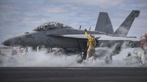 A U.S. Navy officer signals to an EA-18G Growler on the flight deck of the USS Dwight D. Eisenhower on Monday, April 11. The aircraft carrier was in the Atlantic Ocean preparing for a scheduled deployment.