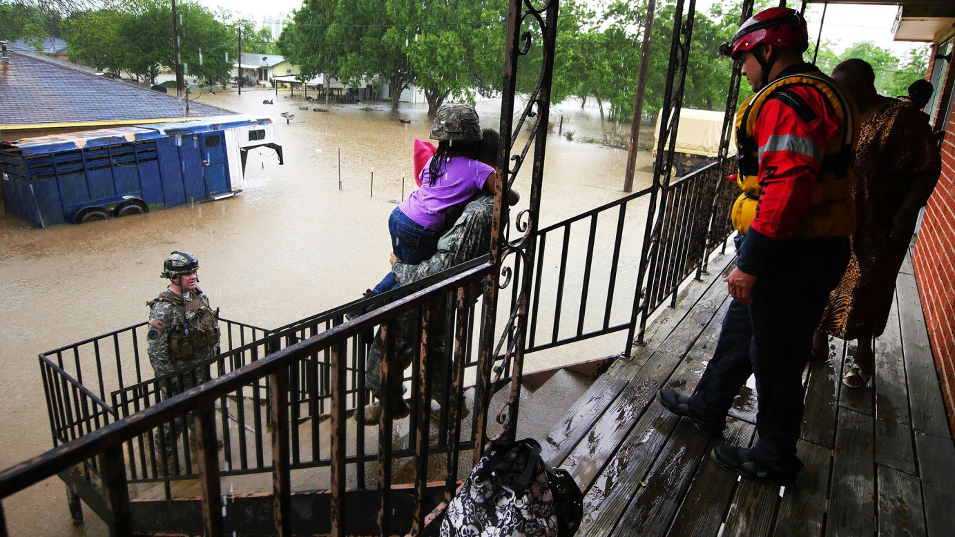 Soldiers and rescue personnel from the Texas Army National Guard help stranded residents during severe flooding in Wharton, Texas, on Thursday, April 21.