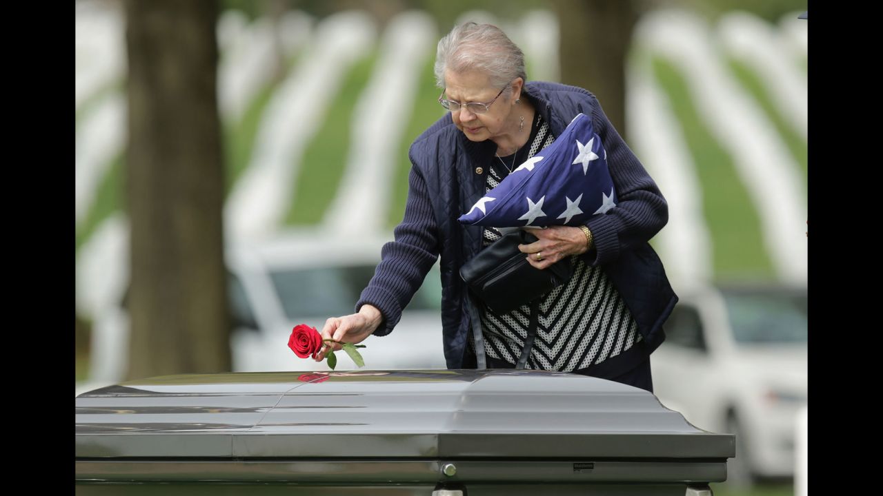Urbana Warfel, 81, places a rose on the casket of her brother, Army Sgt. Wilson Meckley Jr., during his burial ceremony Monday, April 4, at Arlington National Cemetery. Meckley, from Lancaster, Pennsylvania, was declared dead during the Korean War, but his body was never found. Through DNA testing, it was determined that his remains were among those returned to the United States between 1990 and 1994.